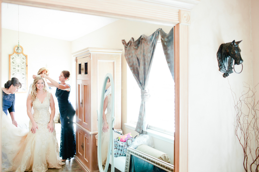 Getting Ready: Bridesmaids Putting on Wedding Veil on Bride