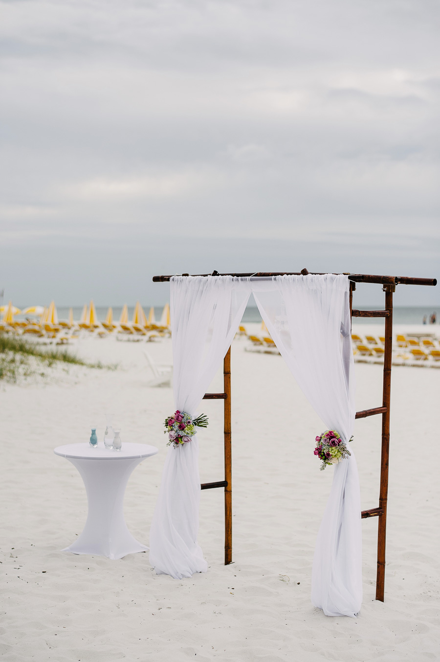 Clearwater Beach Wedding Arch with White Draping Detail and Sand Ceremony Table