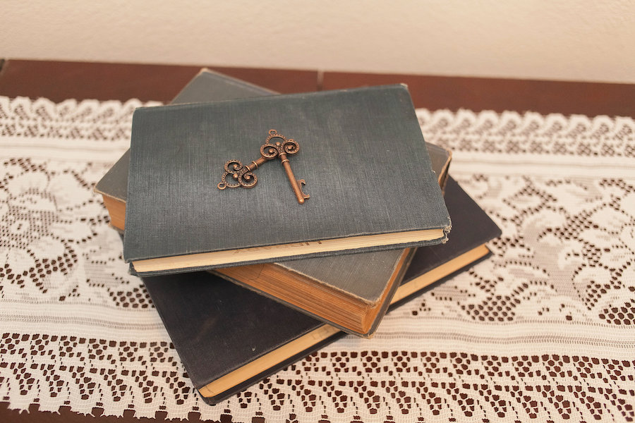 Wedding Reception Decor with Vintage Books and Antique Keys and Lace Linens