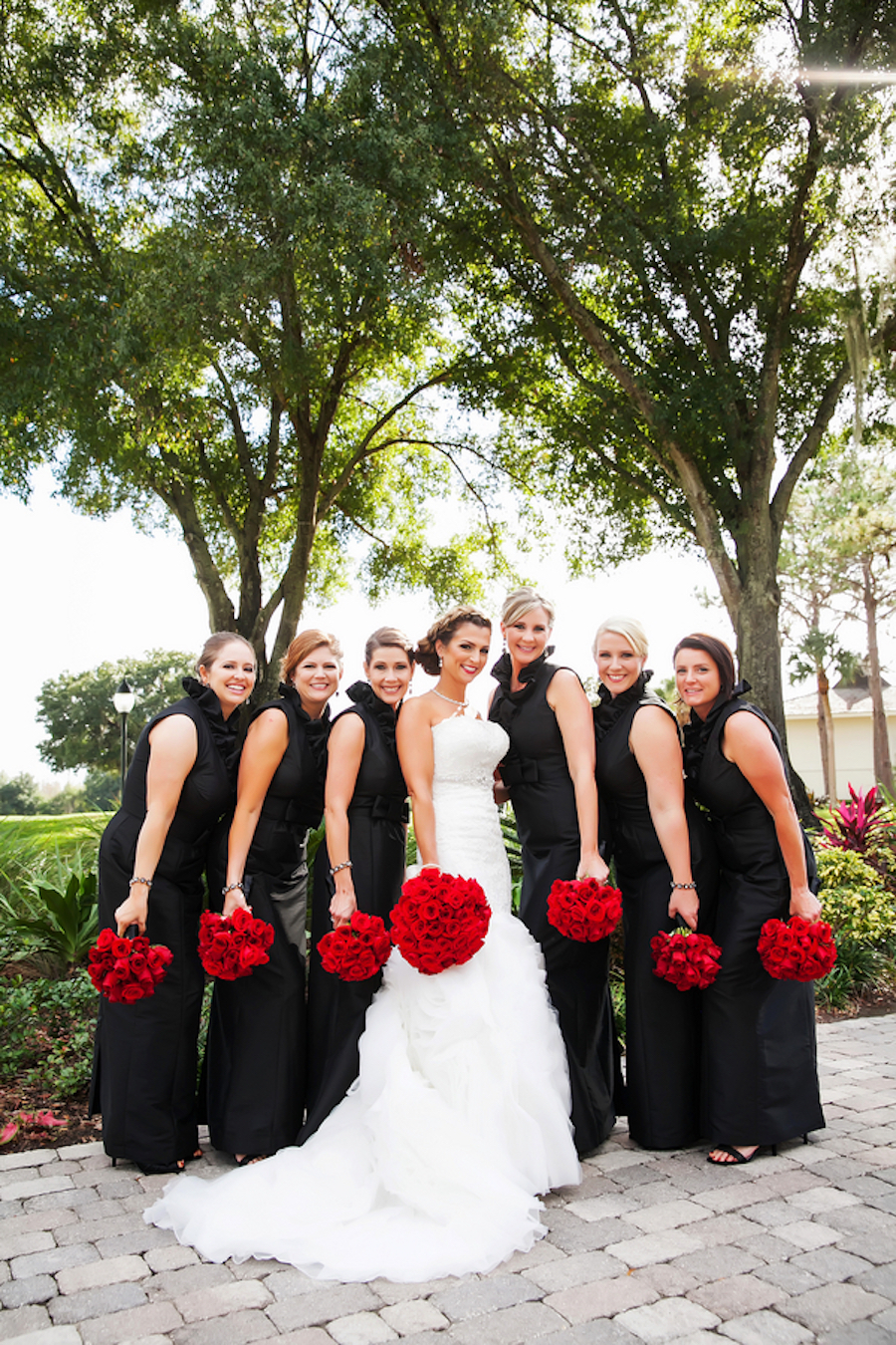 Wedding Party Bridal Portrait| Black Bridesmaid Dresses with Red Rose Bouquets| Photo by Tampa Bay Wedding Photographer Limelight Photography