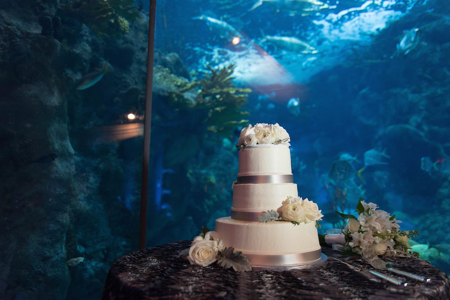 Under the Sea Fish Tank Wedding | Three Tiered White Wedding Cake with Floral Accent | Unique Tampa Bay Wedding Reception at Downtown Tampa Wedding Venue The Florida Aquarium | Photo by Tampa Bay Wedding Photographer Kristen Marie Photography