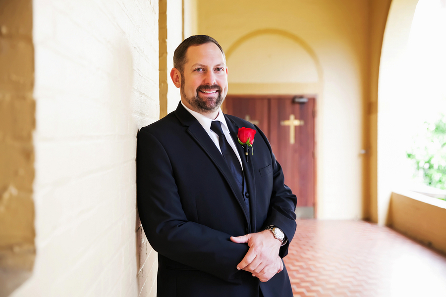 Portrait of Groom on Wedding Day in Black Suit with Red Rose Boutonniere | Photo by Tampa Bay Wedding Photographer Limelight Photography