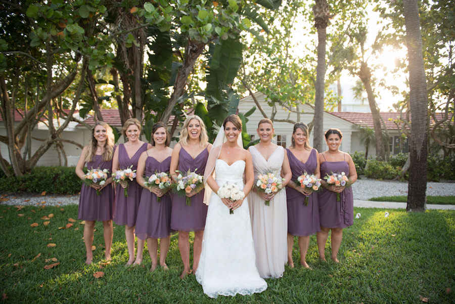 Bride and Bridesmaids in Bridal Wedding Portrait with Strapless, Ivory Wedding Gown and Purple Bella Bridesmaids Dresses