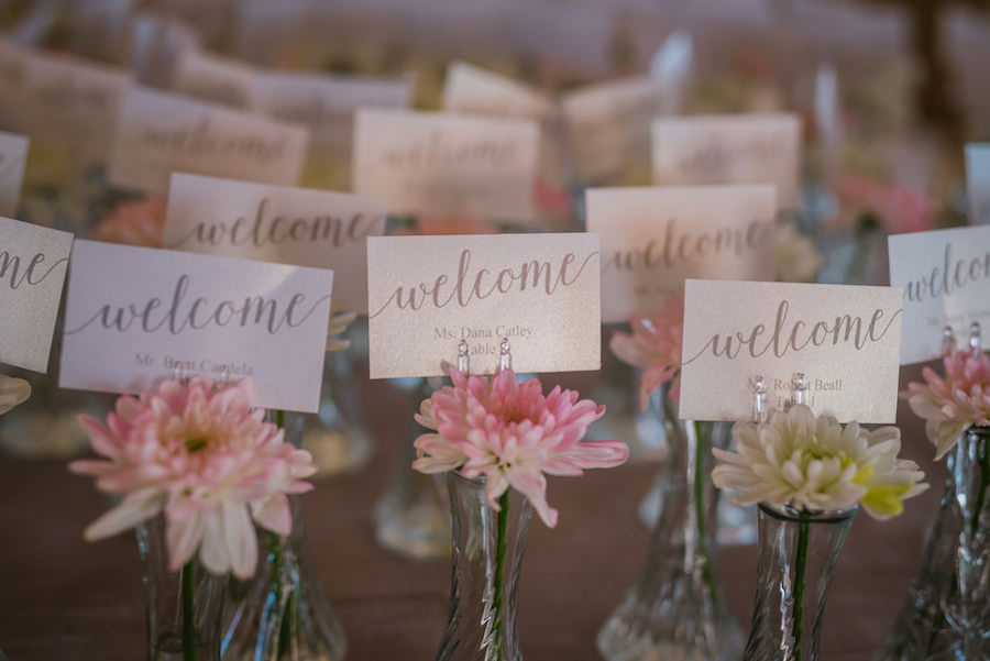 Wedding Reception Decor | Welcome Guest Table Place Cards in Vases with Flowers