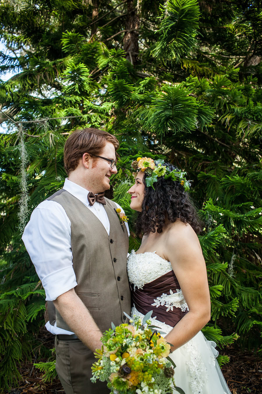 Bride and Groom, Outdoor Woods Wedding Portrait at St. Petersburg Lord of the Rings Inspired Wedding with White and Brown Wedding Dress and Yellow and Green Bouquet of Flowers and Flower Crown | St. Petersburg Wedding Florist Wonderland Floral Art and Gift Loft