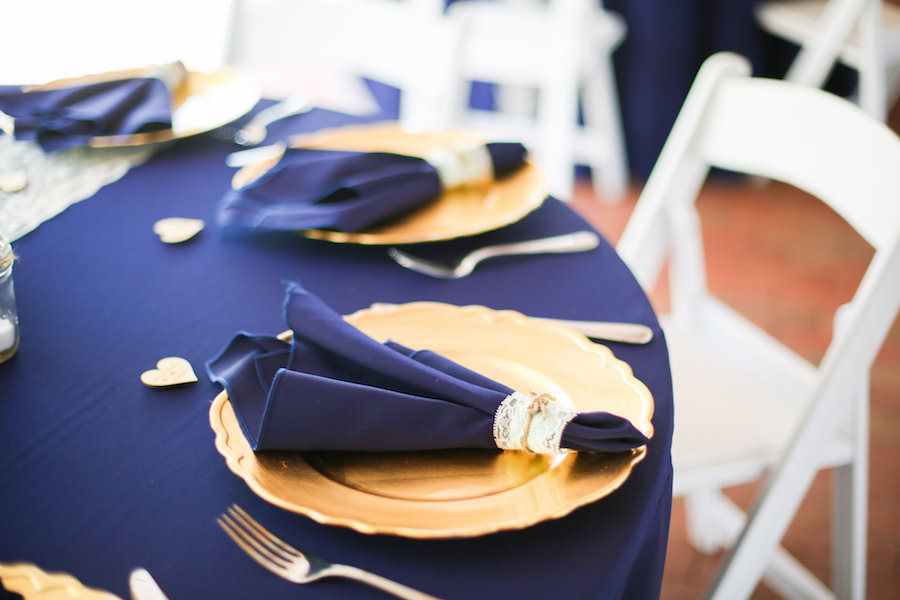 Wedding Reception Table Decor with Navy Blue Linens, Gold Chargers and Lace and Burlap Tie
