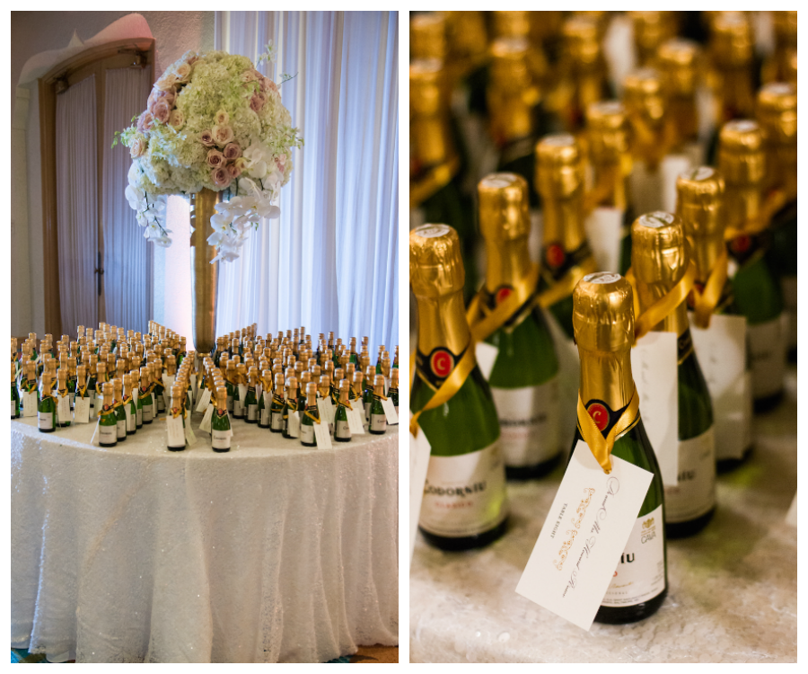 Wedding Guest Favor Table with Miniature Champagne Bottles and Tall, Ivory and Blush Floral Centerpiece