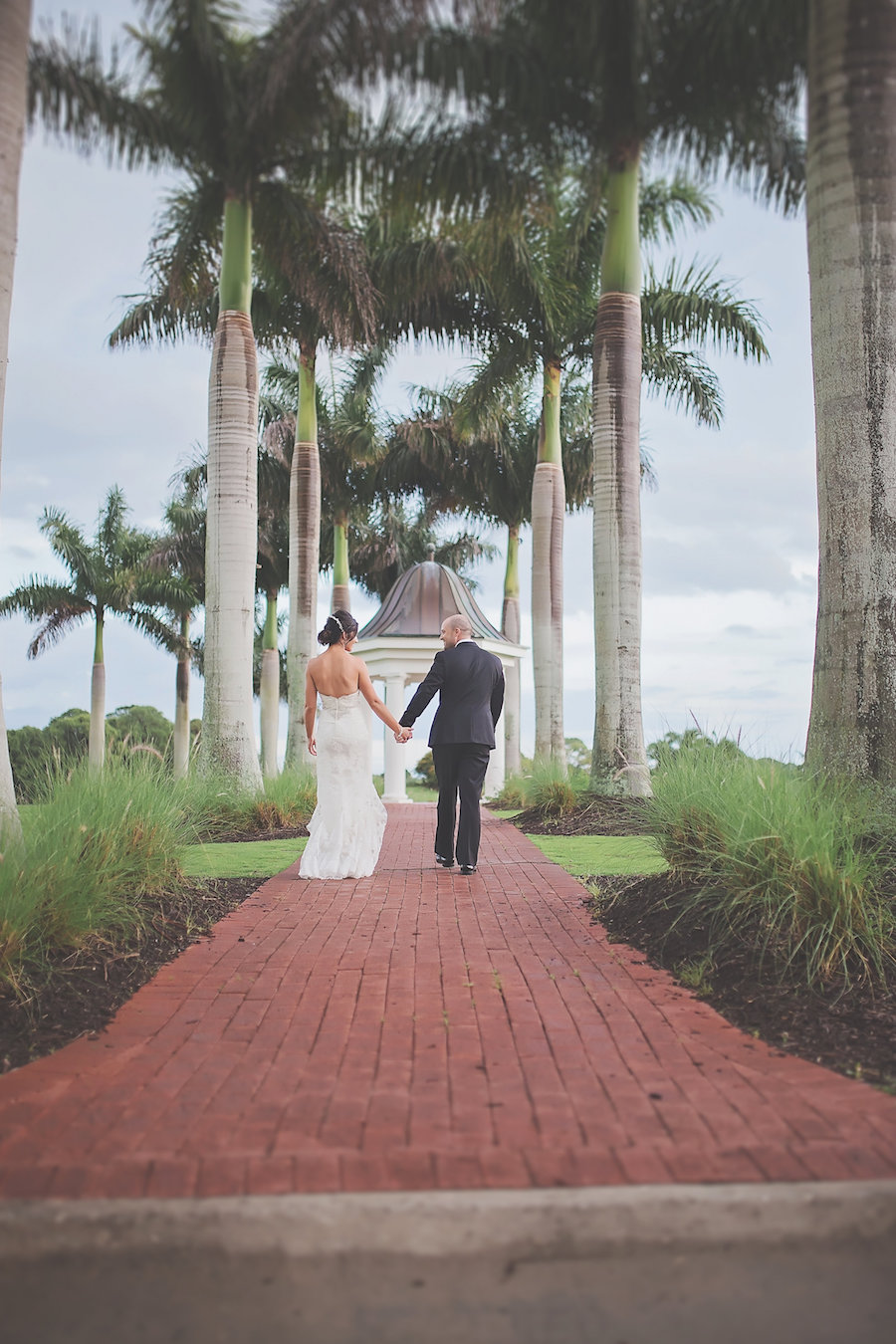 Sarasota, Florida Bride and Groom Wedding Portrait Walking Through Palm Trees