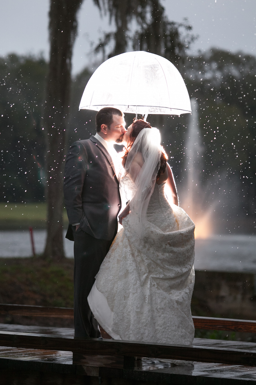 Bride and Groom Wedding Portrait in the Rain with Umbrella by Tampa Bay Wedding Photographer Carrie Wildes Photography