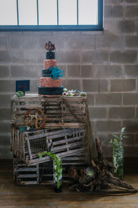 Ybor City Wedding Cake Display Table with Black and Gold Nautical Inspired Wedding Cake With Pirate ship and Octopus on Wooden Fishing Crates | Tampa Wedding Cake Chefin Parties