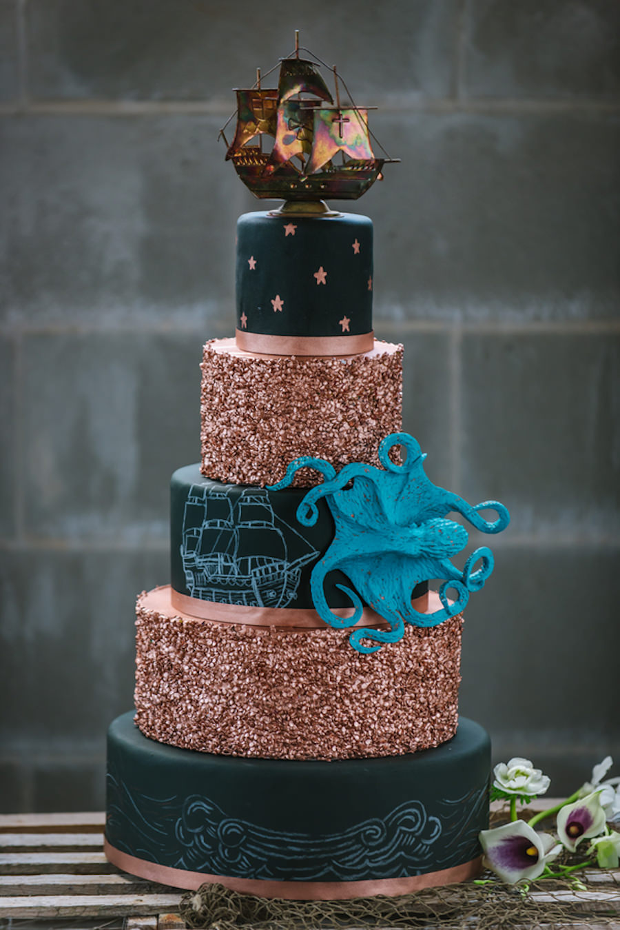 Black and Gold 5 Tiered Nautical Inspired Wedding Cake with Pirate Ship and Octopus Details