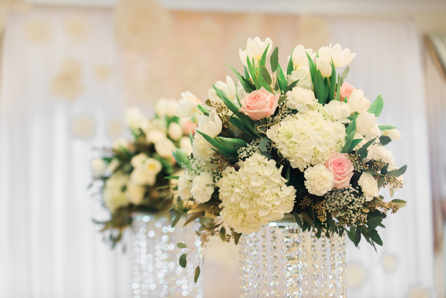 Wedding Reception Table Decor with Ivory and Blush Pink Flower Centerpieces on a Tall, Crystal Stand