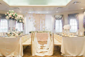 Wedding Reception Decor with Tall, Crystal Centerpieces with Ivory and Blush Pink Flowers, Gold Chiavari Chairs with Ivory Braided Chair Cover Linens and Floral Decorative Backdrop | Tampa Bay Brooksville Wedding Venue Southern Hills Plantation Club