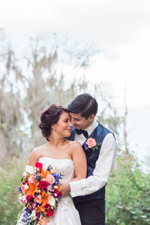 Bride and Groom Wedding Portrait with Bright Orange, Red and Purple Flowers | Tampa Wedding Photographer Jillian Joseph Photography
