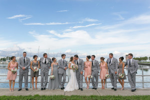 Outdoor Wedding Party Portait in Grey and Light Pink Bridesmaid Dresses with Grey Groomsmen Suits in Downtown St.Pete| Waterfront Bridal Party Portrait | Saint Petersburg Wedding Photographer Roohi Photography