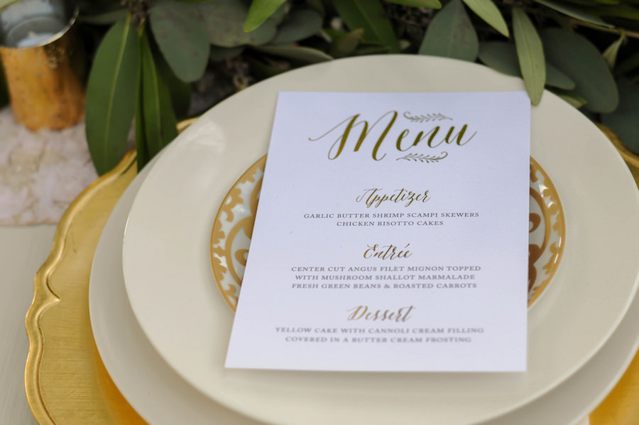 Wedding Reception Place Setting with Custom White Menu Card with Script Gold Accents and Gold Charger Plate