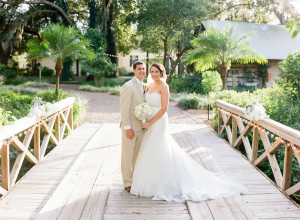 Wedding Portrait of Bride in Strapless Wedding Gown with White Rose Bouquet and Groom in Tan Suit | Cross Creek Ranch Tampa Wedding Venue