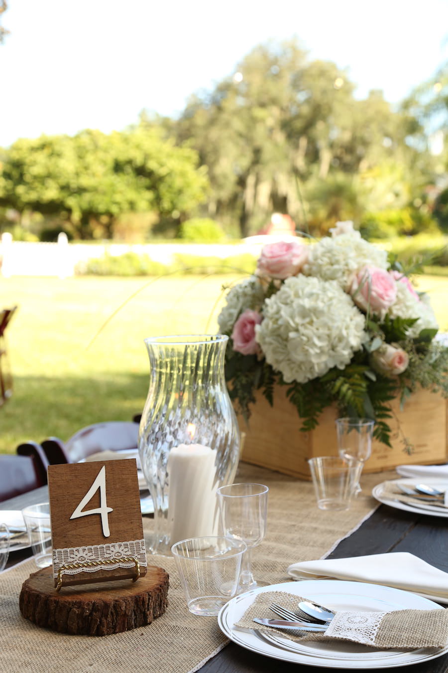 Outdoor, Rustic Lakeland Wedding Reception Table Decor with Wooden Vase and White and Pink Floral Centerpieces in Wooden Box and Candlelight