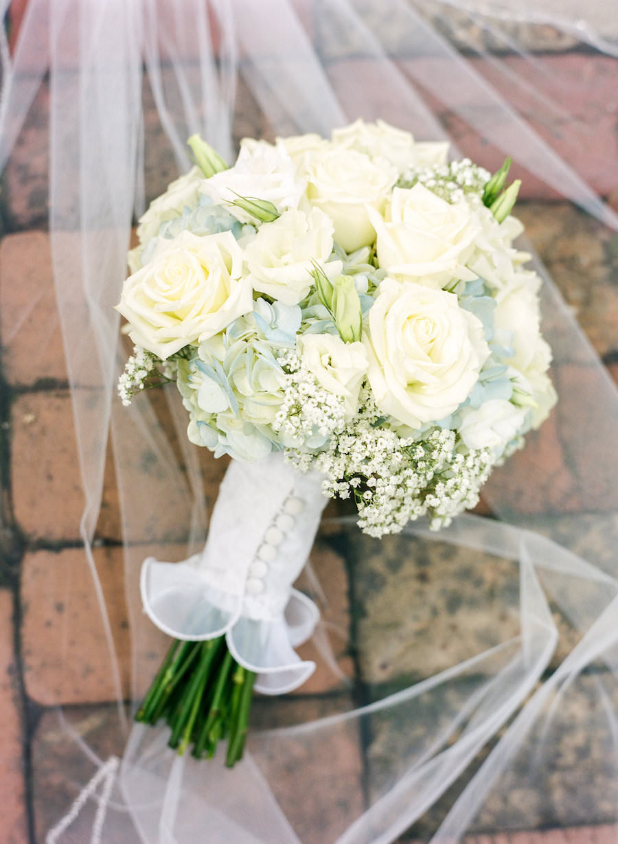 Bride's White Wedding Bouquet with Roses, Hydrangeas and Baby Breath with Veil and Button Detail