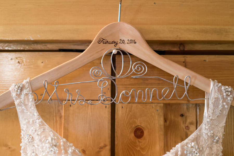 Ivory, Beaded Lace Wedding Dress on Wooden Mrs. Hanger with Wire Groom's Last Name and Wedding Date