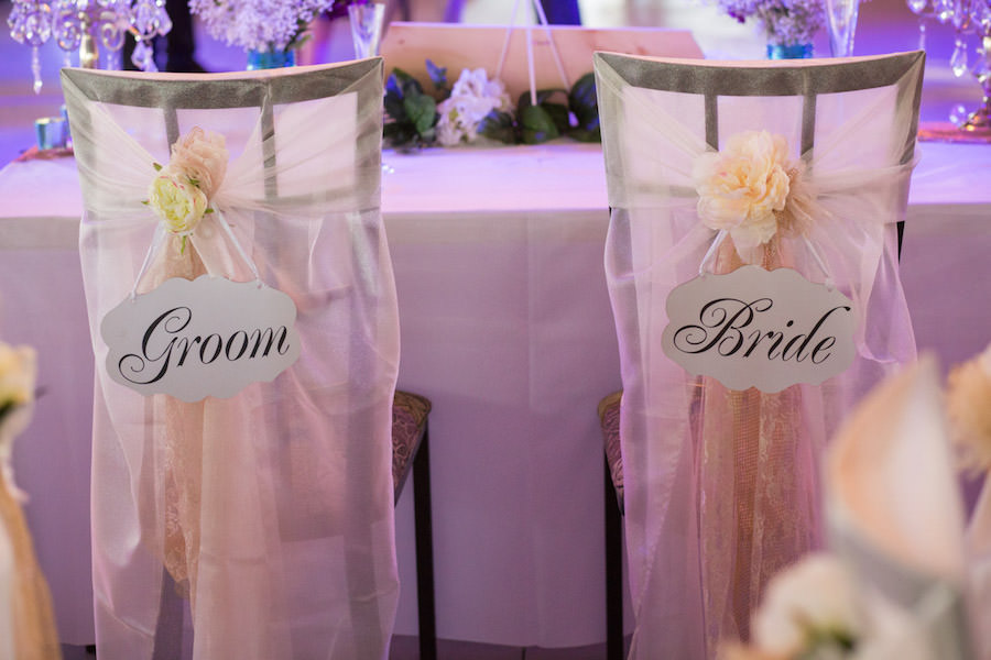 Wedding Reception Decor with Sheer Covered Chairs with Bride and Groom Sign