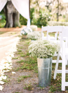 Wedding Ceremony Aisle Decor with White Baby's Breath Flowers and Aluminum Containers with Burlap Aisle Runners and White Wooden Chairs