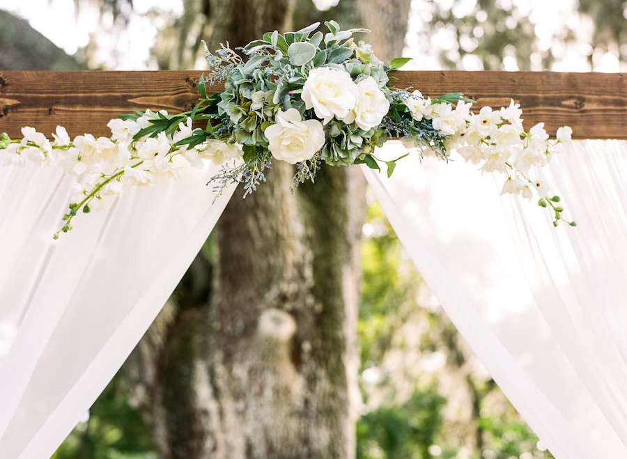 Rustic Wedding Ceremony Altar with White Draped Linens and White and Green Floral Accent