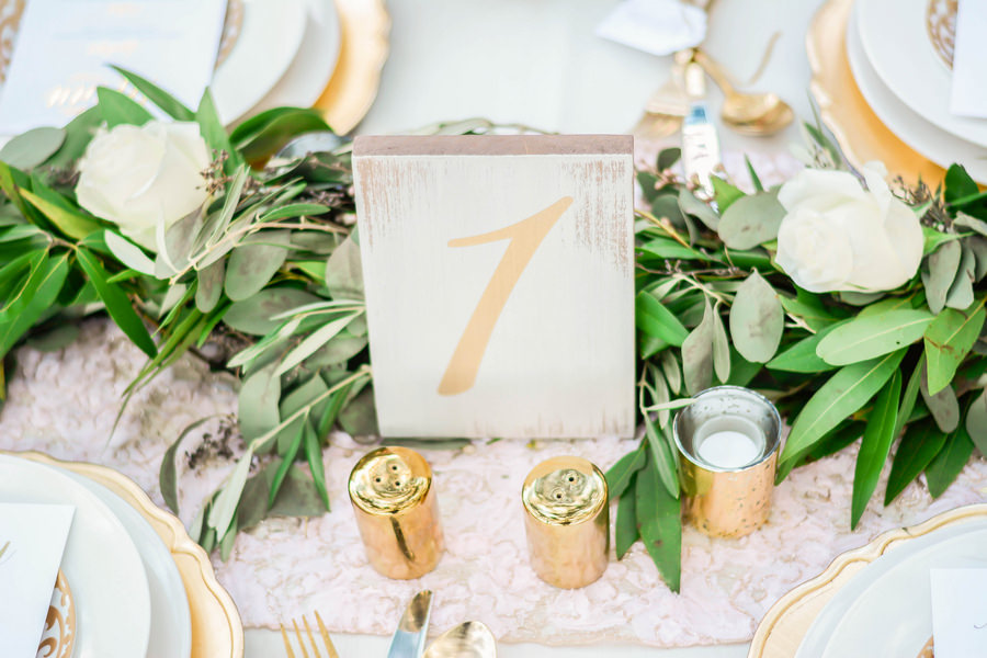 Ivory and Gold Wooden Wedding Table Numbers with Lush Greenery and White Rose Table Runner | Andrea Layne Floral Design