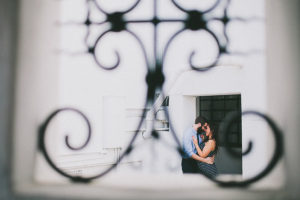 Enagegment Portrait Through Iron Gate | Shuffleboard Courts, Bohemian, Old Florida Inspired Outdoor St. Pete Engagement Photography Session