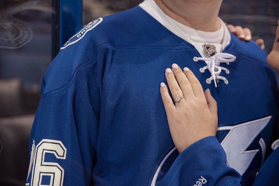 Tampa Lightning Themed Engagement Session at Amalie Arena with Hockey Jerseys and Engagement Ring | Kristen Marie Photography
