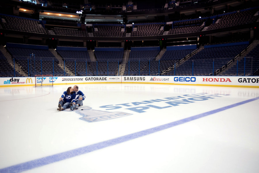 Tampa Lightning Themed Engagement Session at Amalie Arena with Hockey Jerseys on Ice with Stanley Cup Playoffs Logo | Kristen Marie Photography