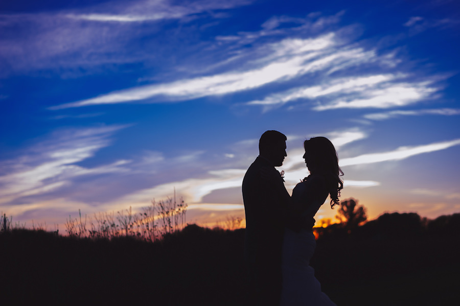 Outdoor, Twilight, Nighttime Bride and Groom Silhouette Wedding Portrait with Blue and Orange Sunset Sky | Tampa Bay Wedding Venue Wishing Well Barn