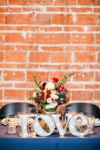 Modern Sweetheart Table with Exposed Brick Wall Lighted LOVE Letters Decor