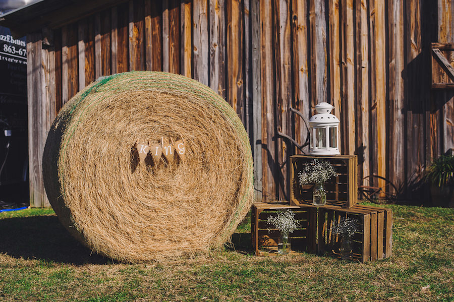 Wedding Reception Rustic Details with Hay Bale and Wooden Crates with Baby's Breath Flowers in Mason Jars