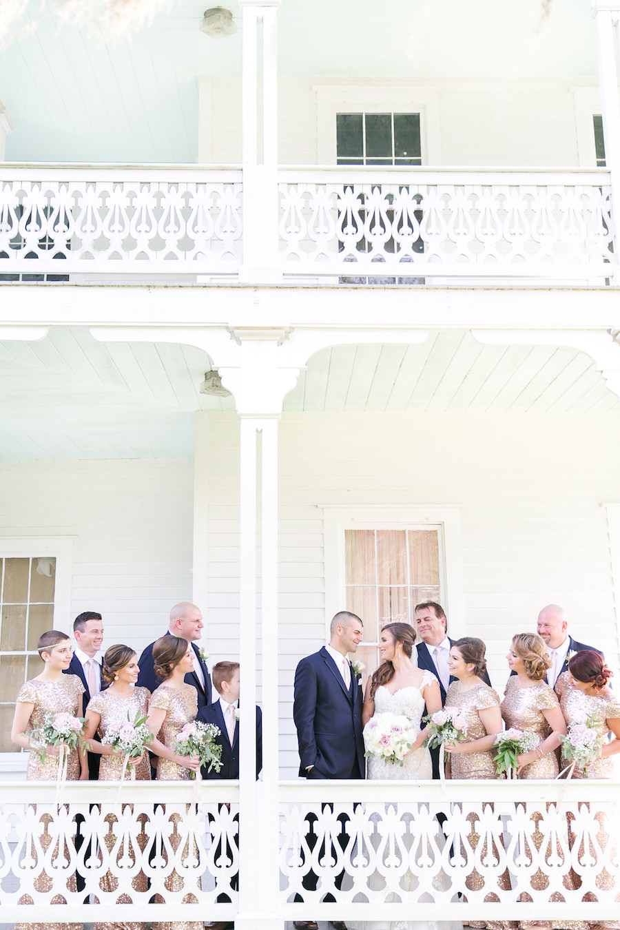 Outdoor Bridal Party Wedding Portrait at Historic Southern Home In Brooksville FL | Rose Gold Sequined Badgley Mischka Bridesmaid Dresses | White and Soft Pink Rose Bouquets | Brides by Demetrios Ivory Lace Wedding Gown