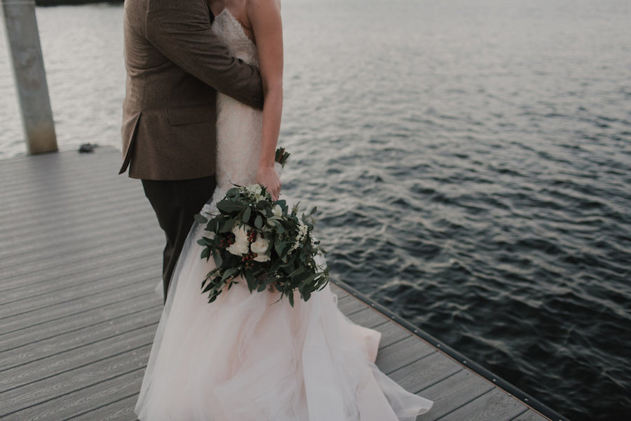 Outdoor, Tampa Waterfront Bride and Groom Wedding Portrait in Strapless JLM Couture Wedding Dress and Ivory and Green Floral Wedding Bouquet