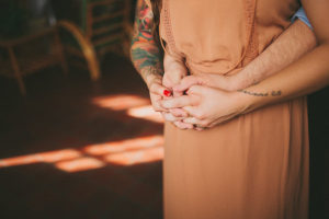 Couple Holding Hands| Bohemian, Old Florida Inspired Outdoor St. Pete Engagement Photography Session