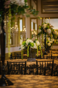 Cascading White and Green Hydrangea and Spider Flower Wedding Centerpiece in Dark Bronze Vase on Embroidered Gold Tablecloths | Tampa Wedding Florist Apple Blossoms Floral Designs