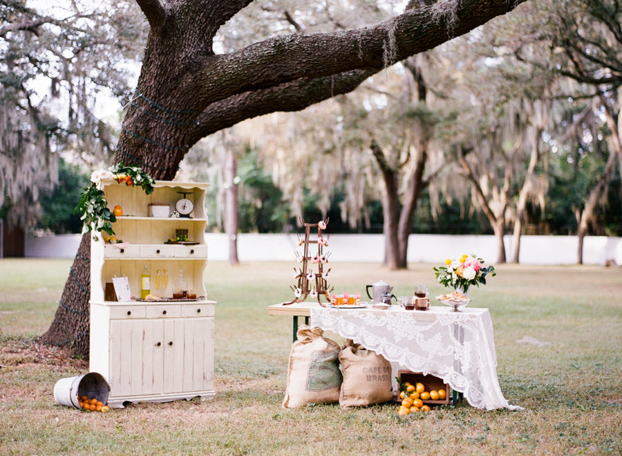 Vintage China Curio Cabinet and Brunch Pastry Buffet with Orange Citrus Wedding Decor and Lace Linens | Tampa Bay Rentals by Tufted Vintage Rentals