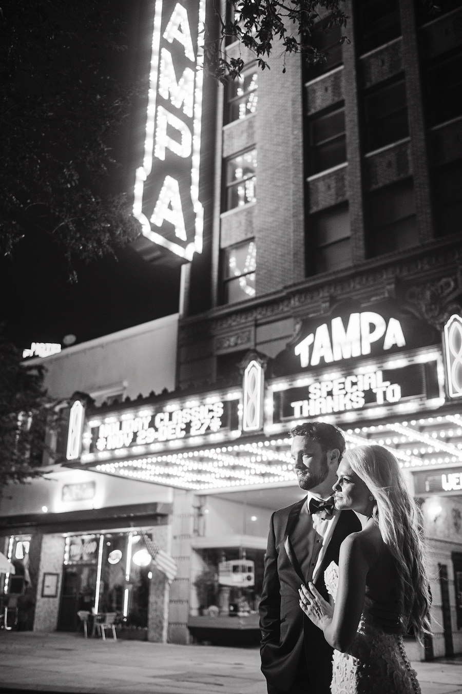 Outdoor, Nighttime, Downtown Tampa Bride and Groom Wedding Portrait at Tampa Theatre Marquee | Tampa Wedding Photographer Marc Edward Photographs