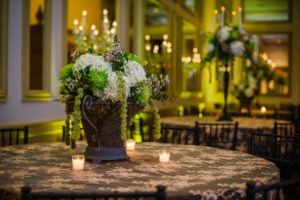 Elegant Wedding Reception with Green, Gold and Ivory Centerpieces in Bronze Rod Iron Vase on Gold Tablecloth | Tampa Wedding Florist Apple Blossoms Floral Designs