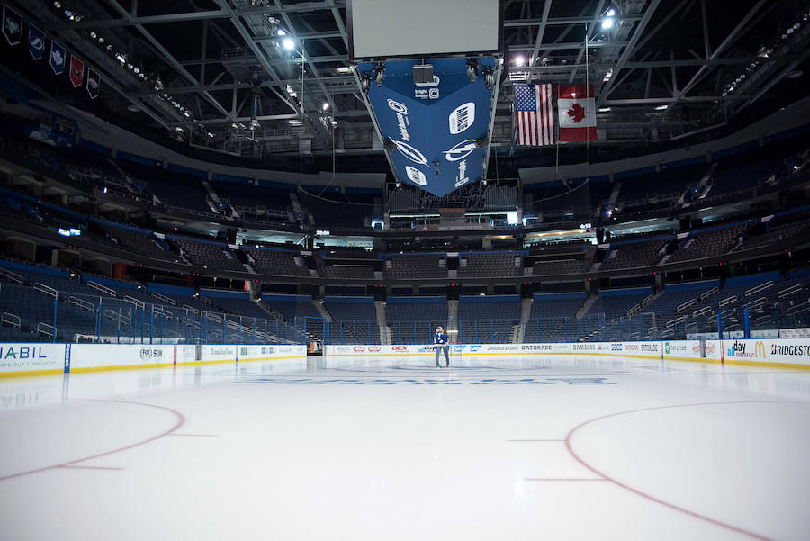 Tampa Lightning Themed Engagement Session at Amalie Arena with Hockey Jerseys on Ice | Kristen Marie Photography