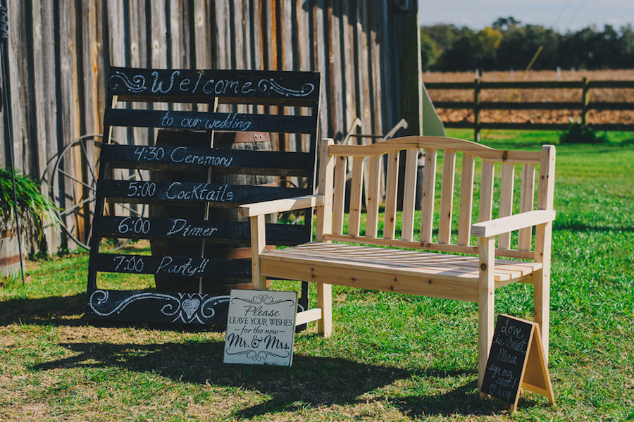 \Wedding Ceremony Wooden Bench and Wooden Pallet and Chalkboard Signs | Plant City Wedding Venue Wishing Well Barn