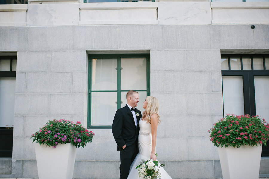 Outdoor, Downtown Tampa Bride and Groom Wedding Portrait in Black Tuxedo and Ivory, Strapless Sweetheart Hayley Paige Wedding Dress with Crystal Rhinestone Wedding Belt Sash