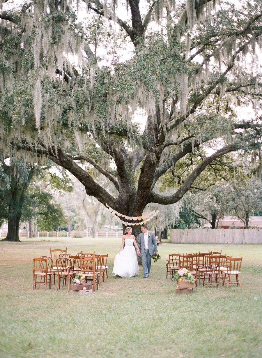 Vintage Outdoor Wedding Ceremony under Spanish Moss Tree with Mis-Matched Wooden Ceremony Chairs | Tampa Bay Rentals by Tufted Vintage Rentals