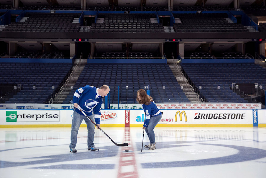 Tampa Lightning Themed Engagement Session at Amalie Arena with Hockey Jerseys, Sticks and Net on Ice | Kristen Marie Photography