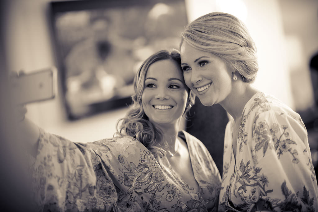 Bride and Bridesmaid Taking Selfie Getting Ready Portrait in Paisley Floral Robes