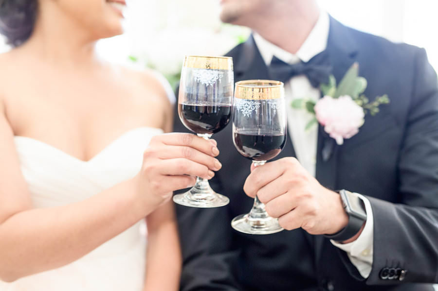 Bride and Groom Toasting with Red Wine on Wedding Day