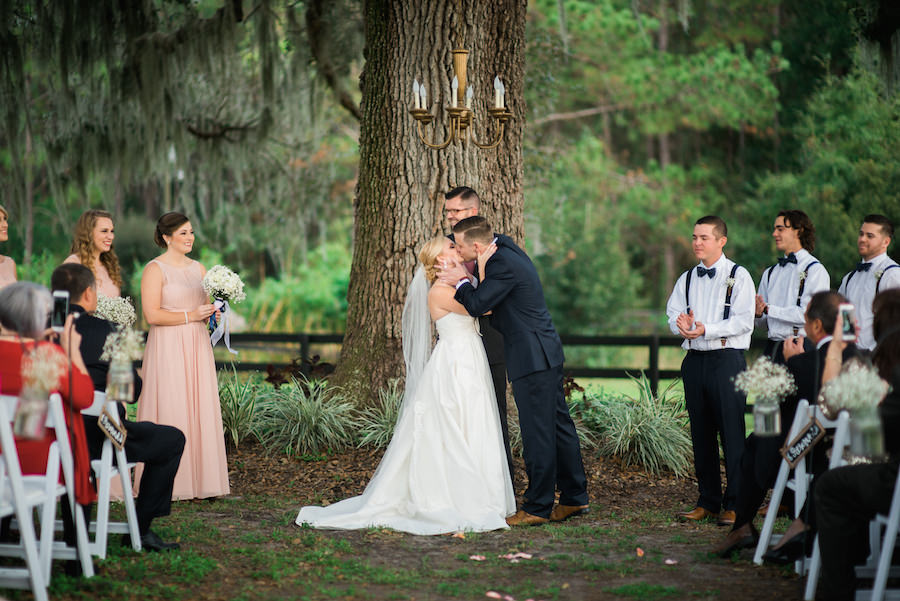 Vintage, Southern Outdoor Wedding Ceremony Under Spanish Moss Tree with Hanging Brass Chandelier and White Folding Chairs | Tampa Bay Wedding Photographer Kera Photography