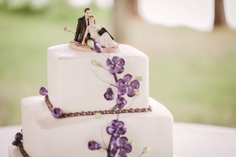 Two Tiered, White Square Wedding Cake with Purple Flower Painted and Bride and Groom Cake Topper
